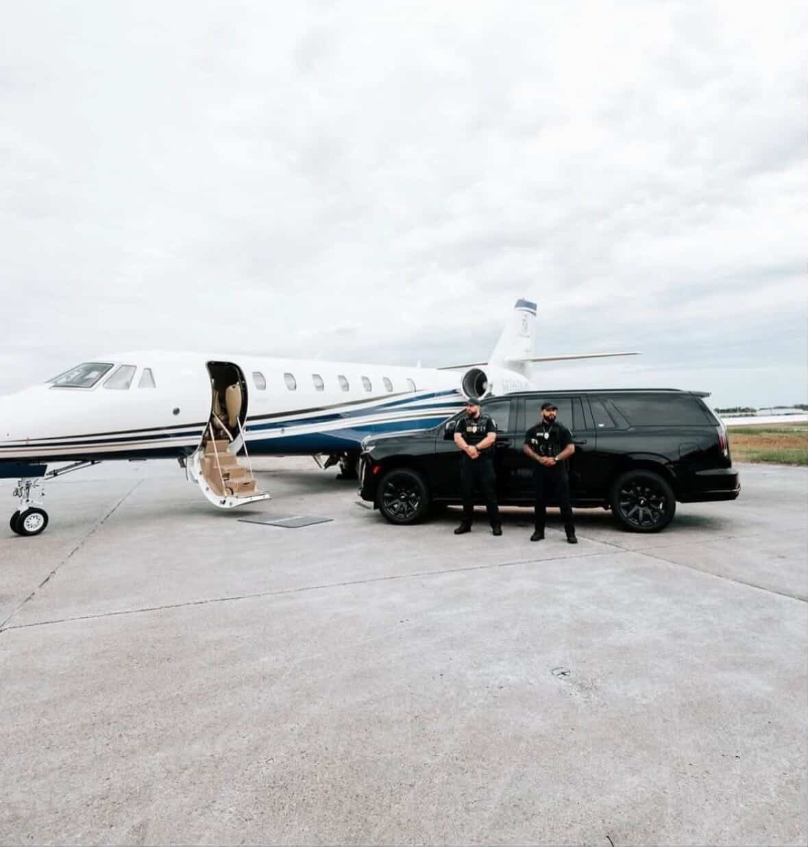 Optimum Exotics security detail and Cadillac Escalade beside a private jet on the tarmac